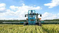 Irrigation of crop field with tractor